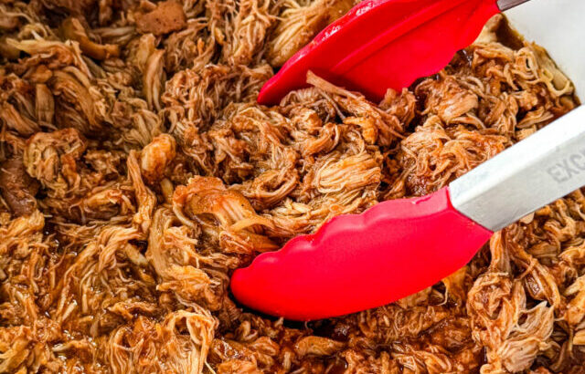 pulled chicken and BBQ sauce in a white Crockpot slow cooker