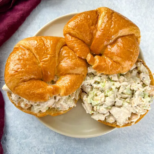 classic chicken salad on a croissant sandwich on a plate