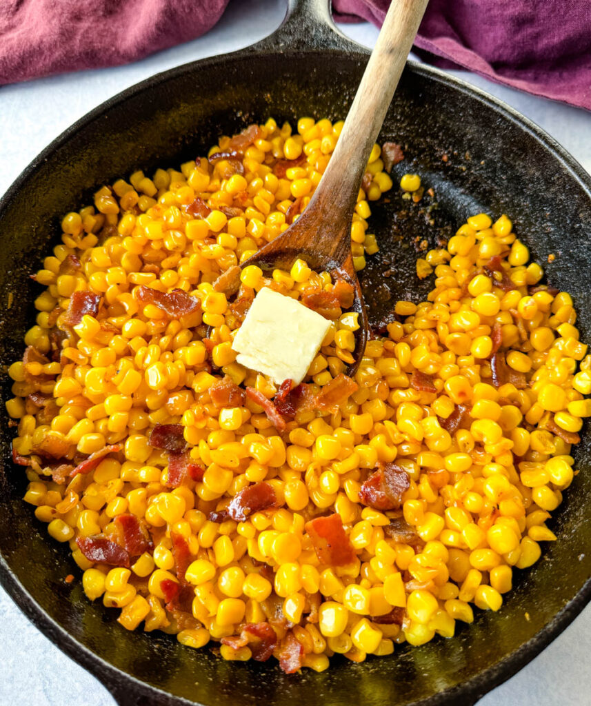 Southern fried corn with butter and bacon in a cast iron skillet