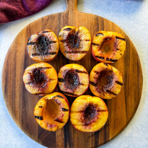 grilled peaches on a flat surface