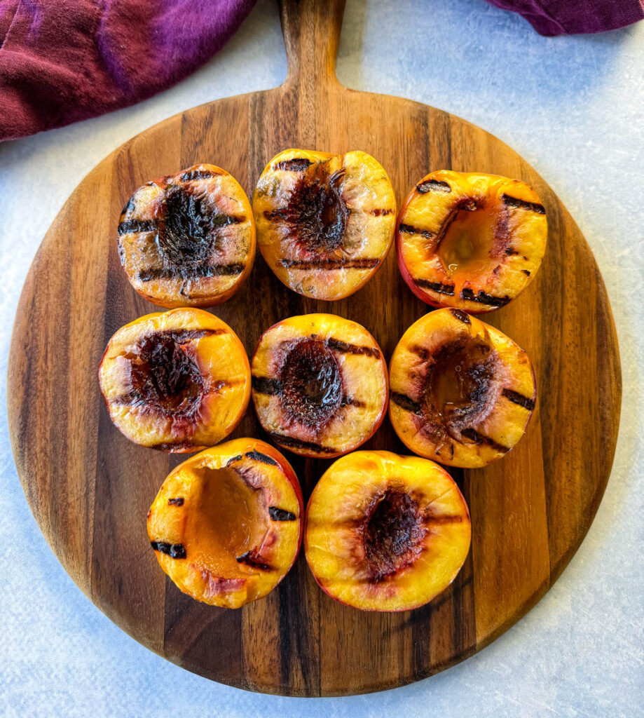 grilled peaches on a flat surface