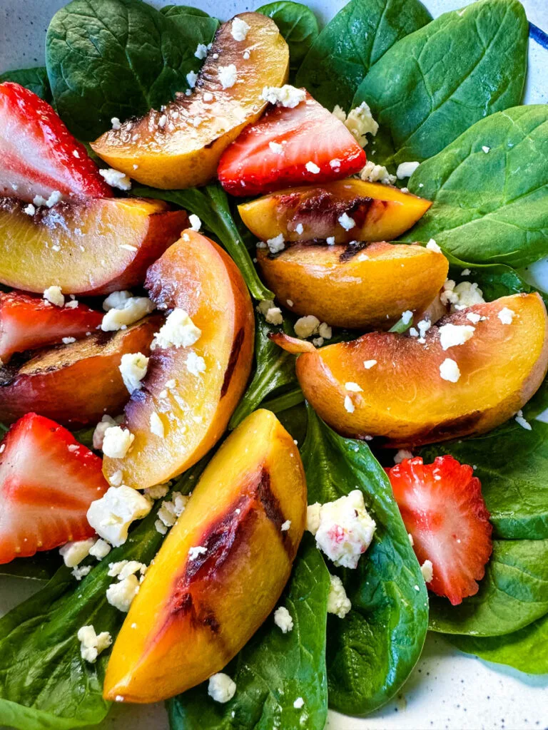 salad with grilled peaches, strawberries, and cheese