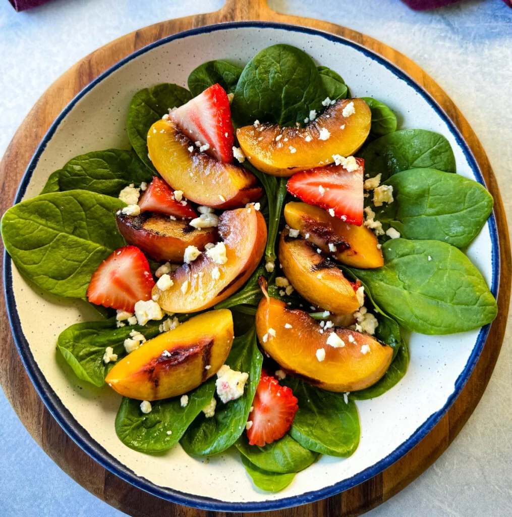 salad with grilled peaches, strawberries, and cheese