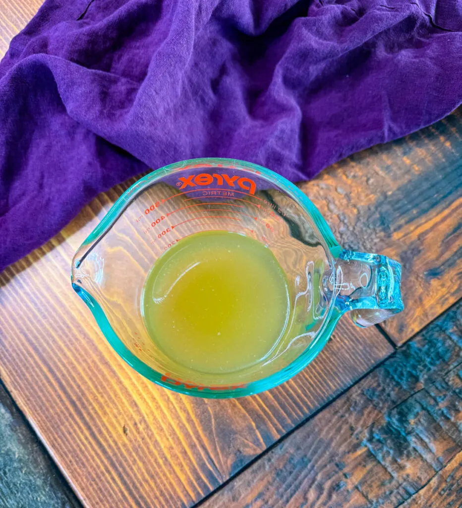 chicken broth in a glass measuring cup