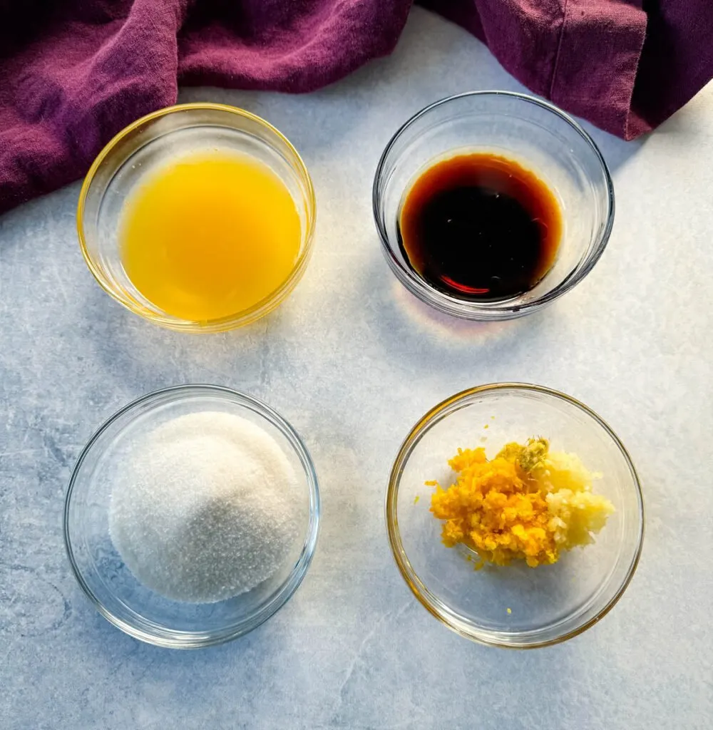 orange juice, orange zest, sweetener, soy sauce, rice wine vinegar, and sesame oil in separate glass bowls