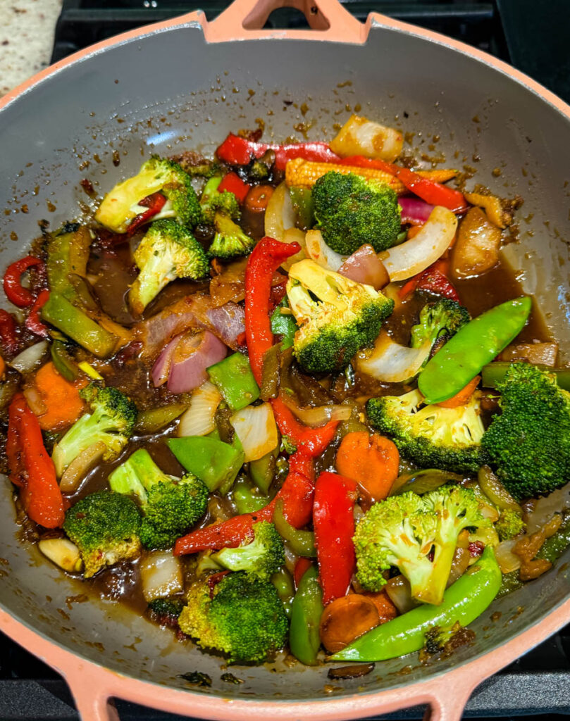 stir fry vegetables with orange sauce in a skillet
