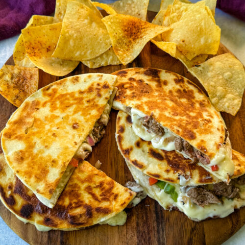 Philly cheesesteak quesadillas on a plate with chips