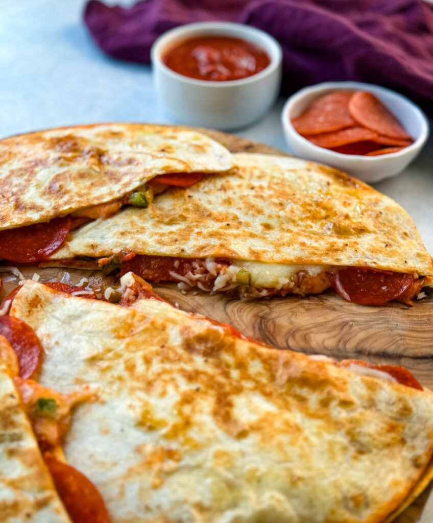 pizza quesadillas with pepperoni on a flat surface
