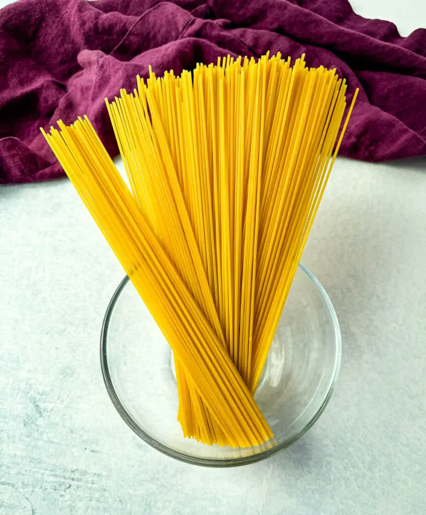 dry spaghetti pasta in a glass bowl