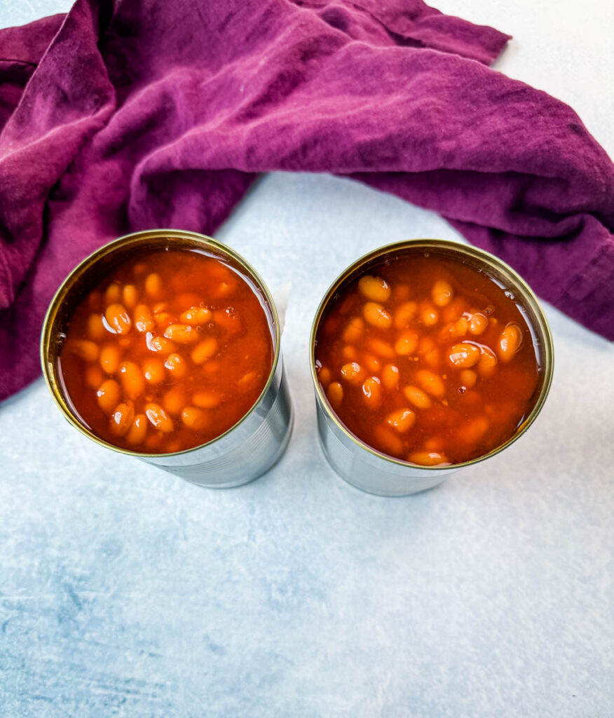 canned baked beans on a flat surface