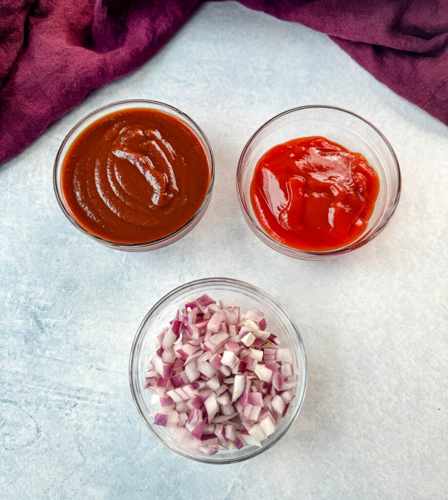 BBQ sauce, ketchup, and diced onions in a glass bowl