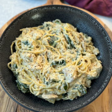 slow cooker Crockpot chicken alfredo in a black bowl