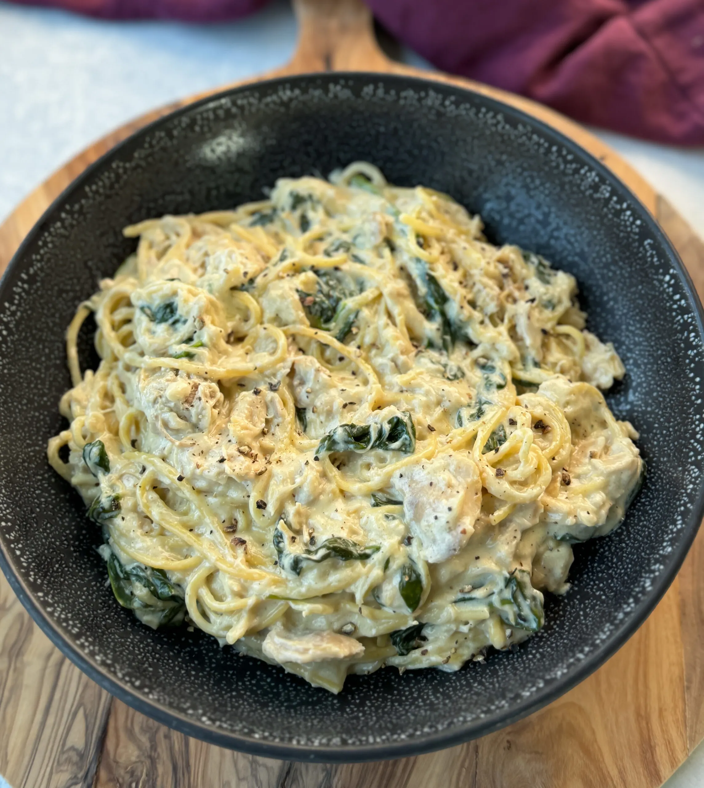 slow cooker Crockpot chicken alfredo in a black bowl