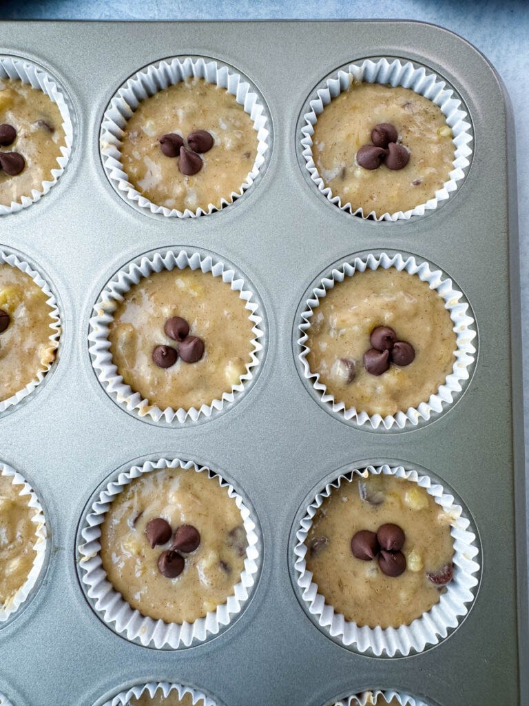 unbaked banana protein muffin with chocolate chips in a muffin tin