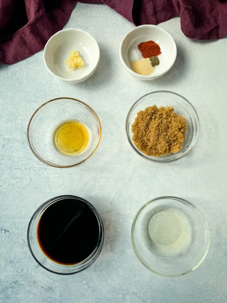 garlic, spices, rice vinegar, soy sauce, brown sugar or sweetener, and sesame oil in separate glass bowls