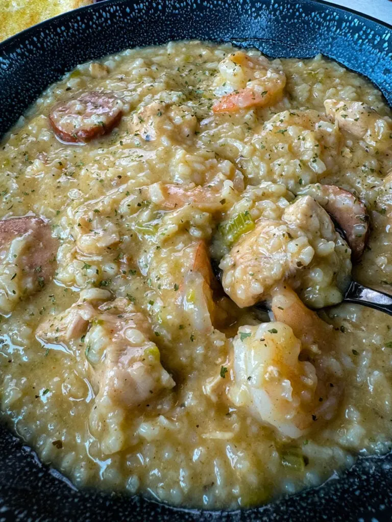 Cajun jambalaya soup in a black bowl