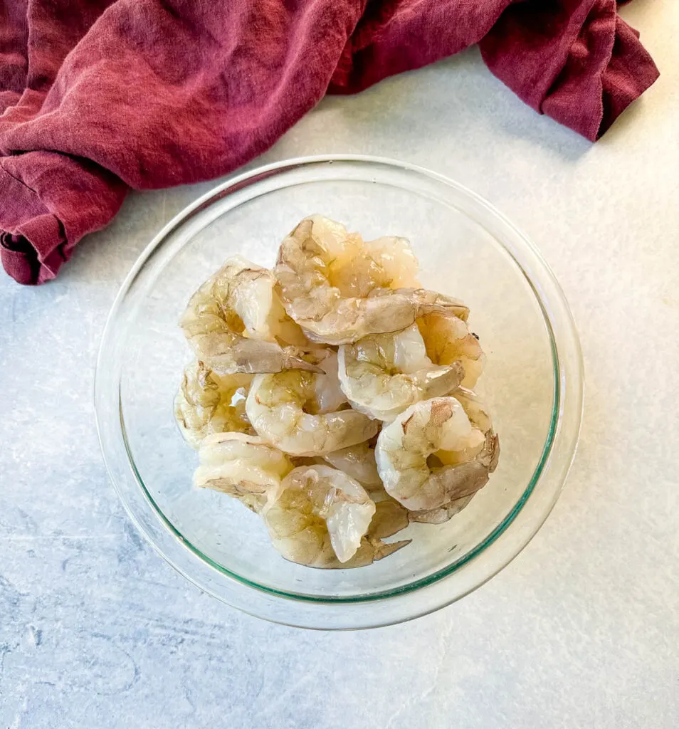 raw peeled shrimp in a glass bowl