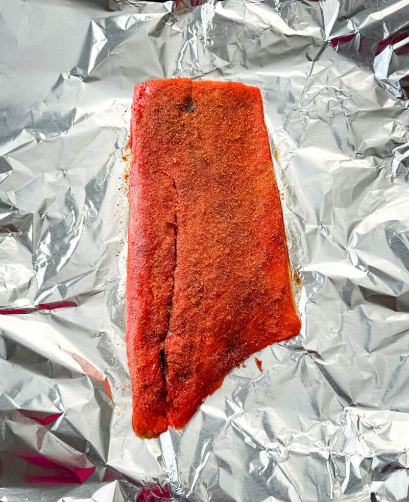raw seasoned salmon on foil