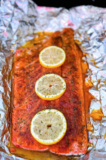 grilled salmon in foil with fresh lemons