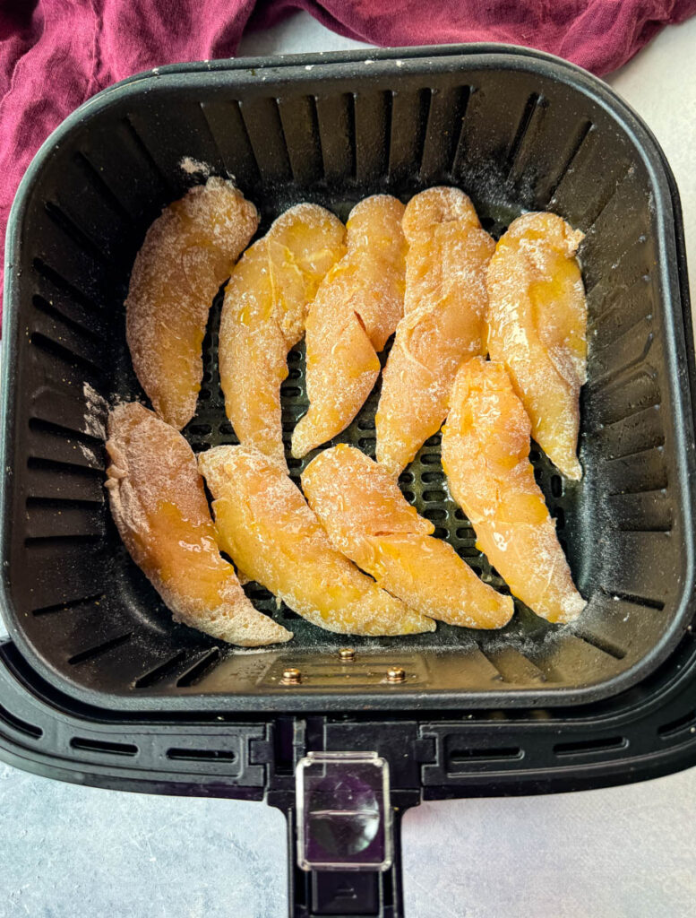 raw seasoned chicken tenders in an air fryer