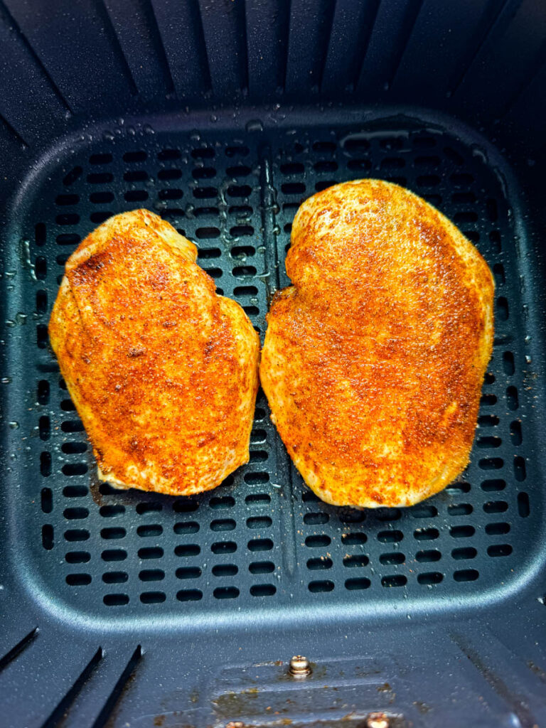cooked and seasoned chicken breast in an air fryer