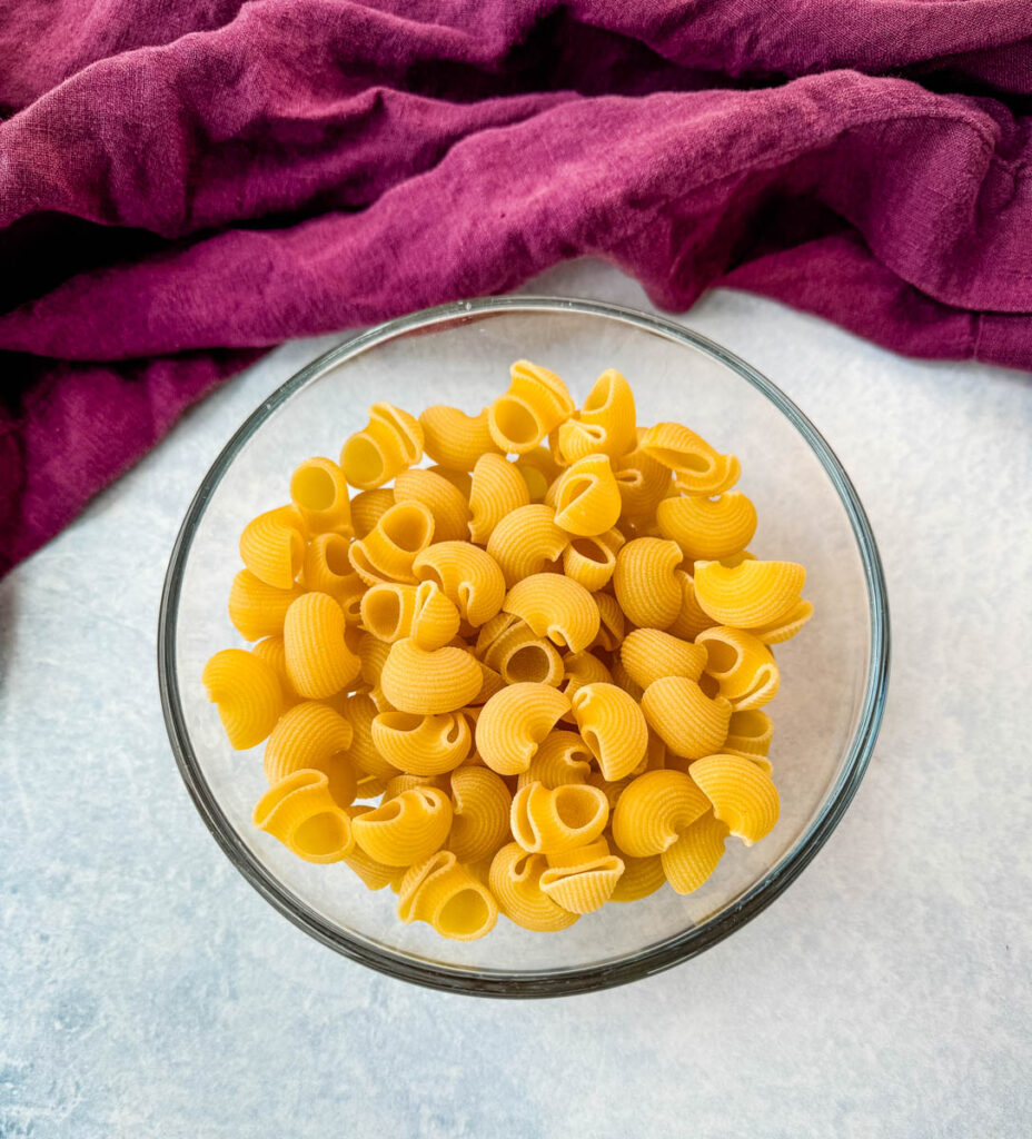 elbow macaroni pasta in a glass bowl