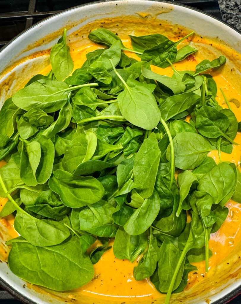 marry me Tuscan chicken soup with spinach in a Dutch oven