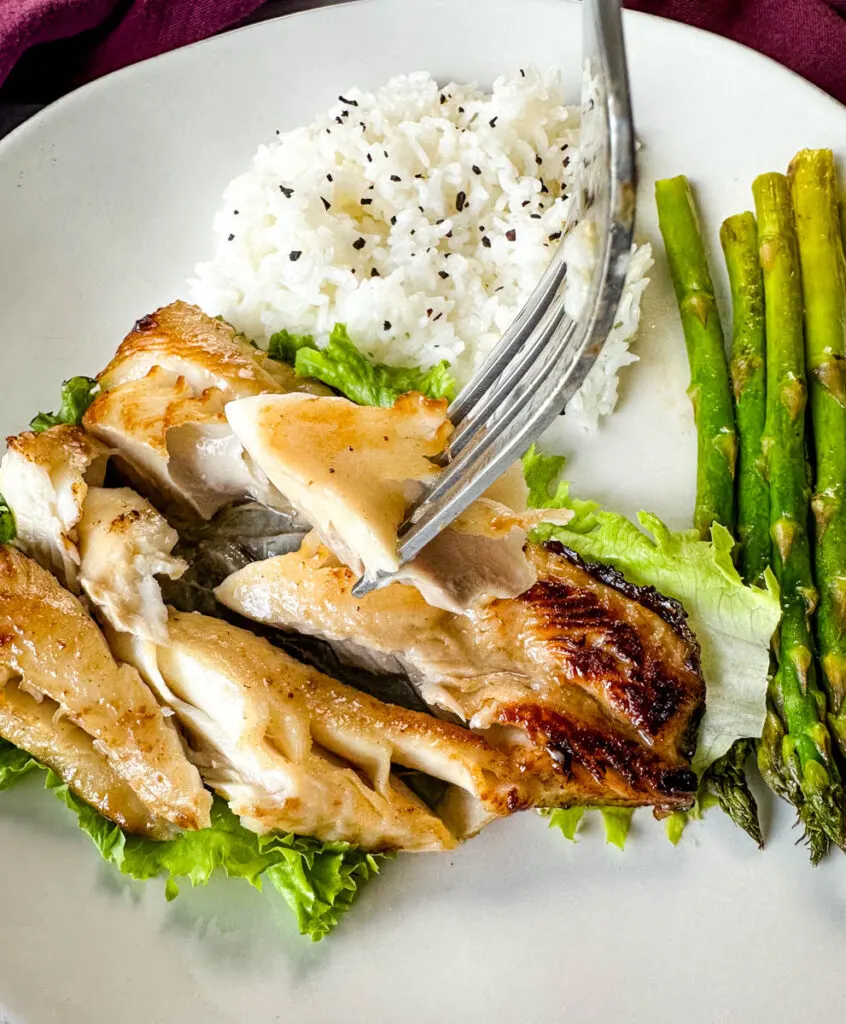 Nobu miso black cod on a plate with white rice and asparagus