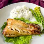 Nobu miso black cod on a plate with white rice and asparagus