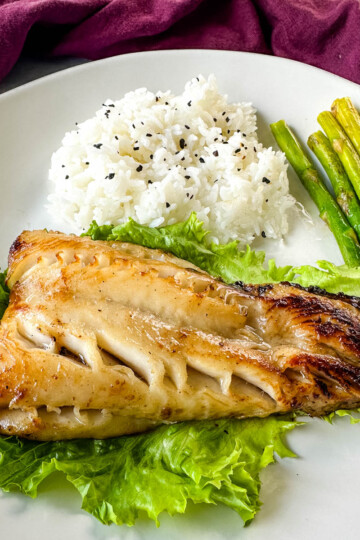 Nobu miso black cod on a plate with white rice and asparagus