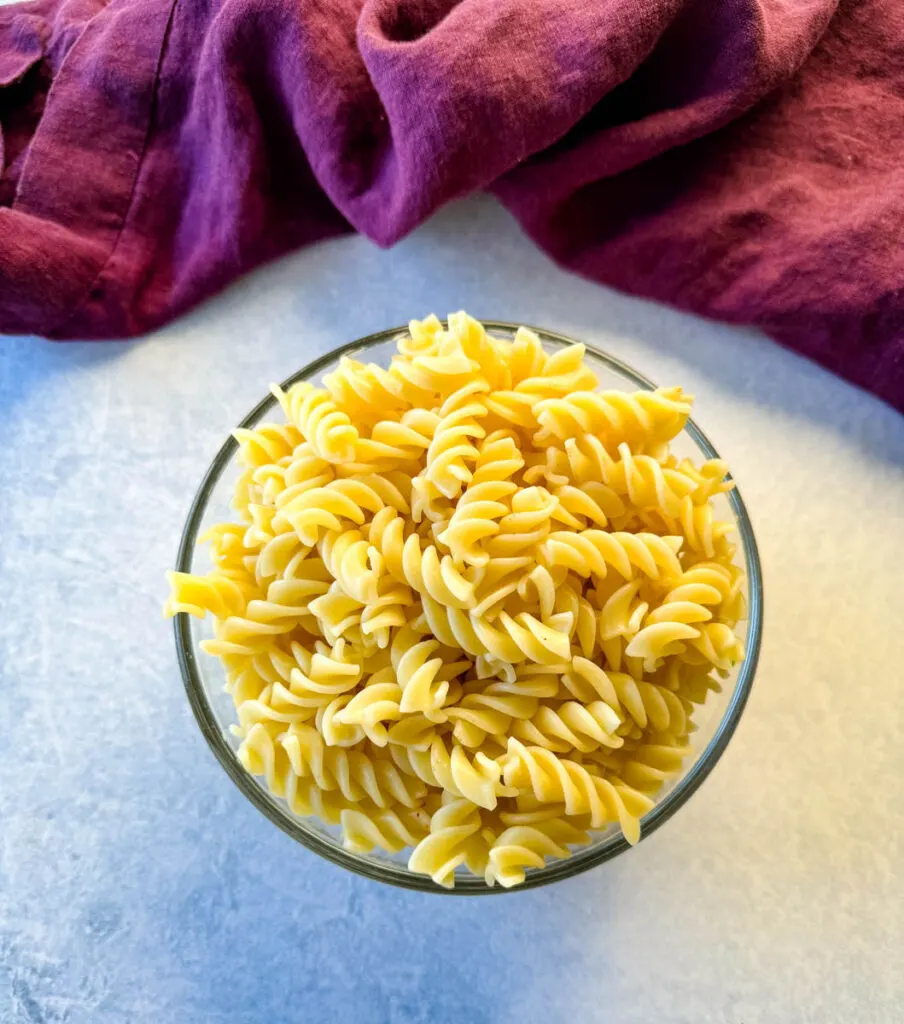 cooked rotini pasta in a glass bowl