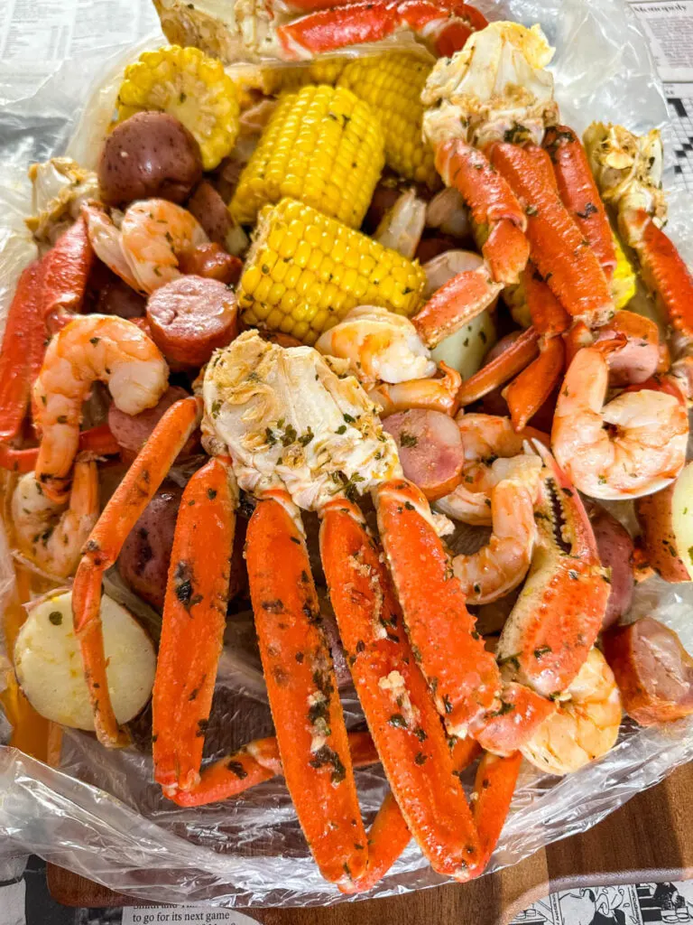 seafood boil in a bag wih snow crab clusters, shrimp, potatoes, corn on the cob and sausage