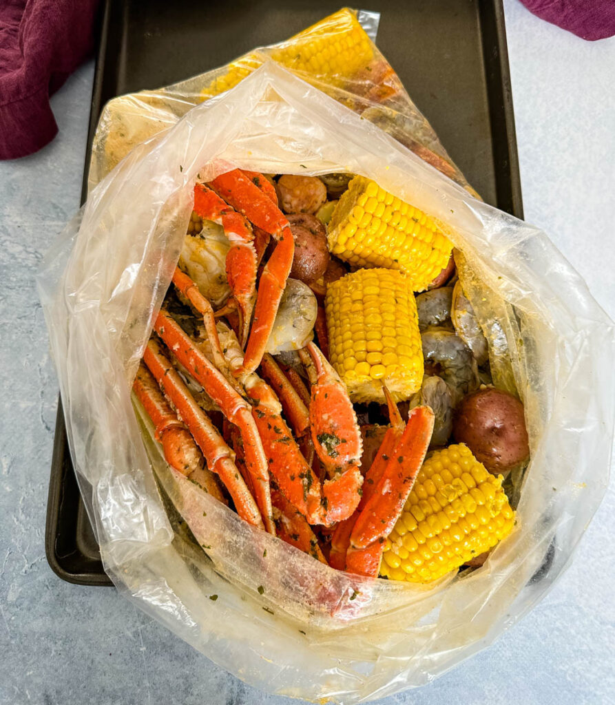 seafood boil in a bag wih snow crab clusters, shrimp, potatoes, corn on the cob and sausage