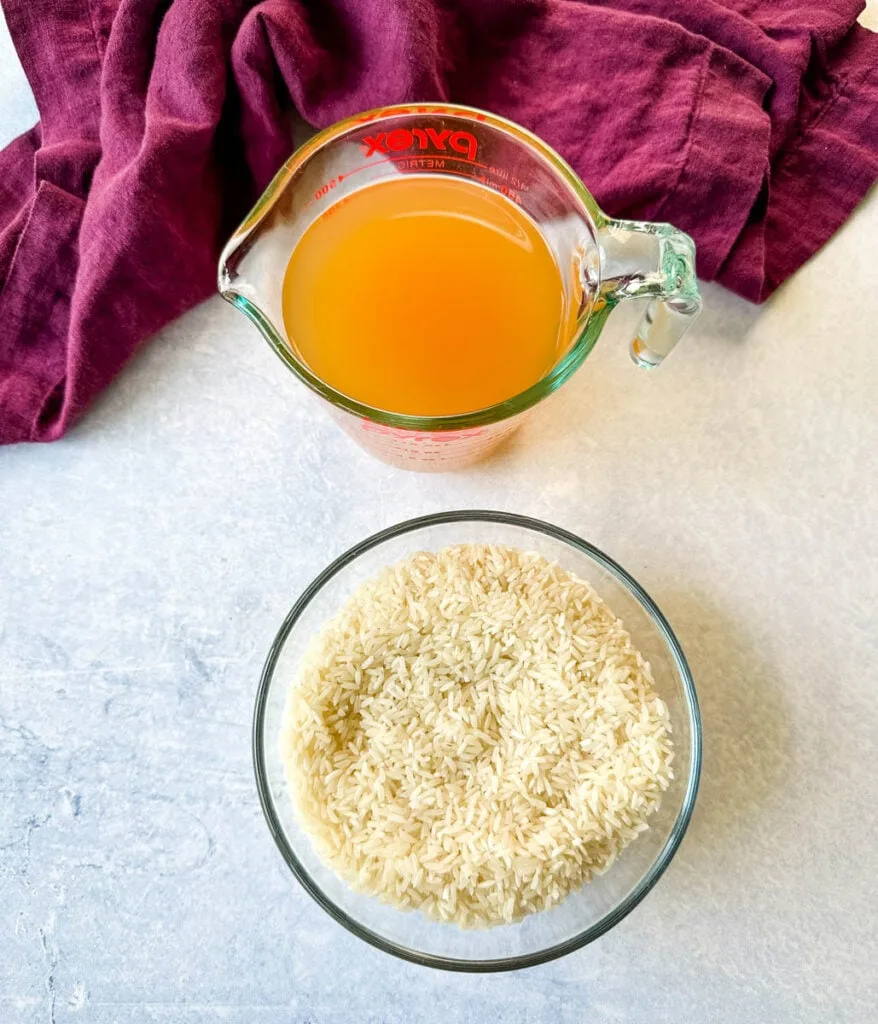 chicken broth and white rice in separate glass bowls