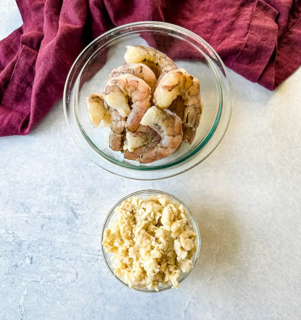 raw shrimp peeled and deveined and lump crab in separate glass bowls