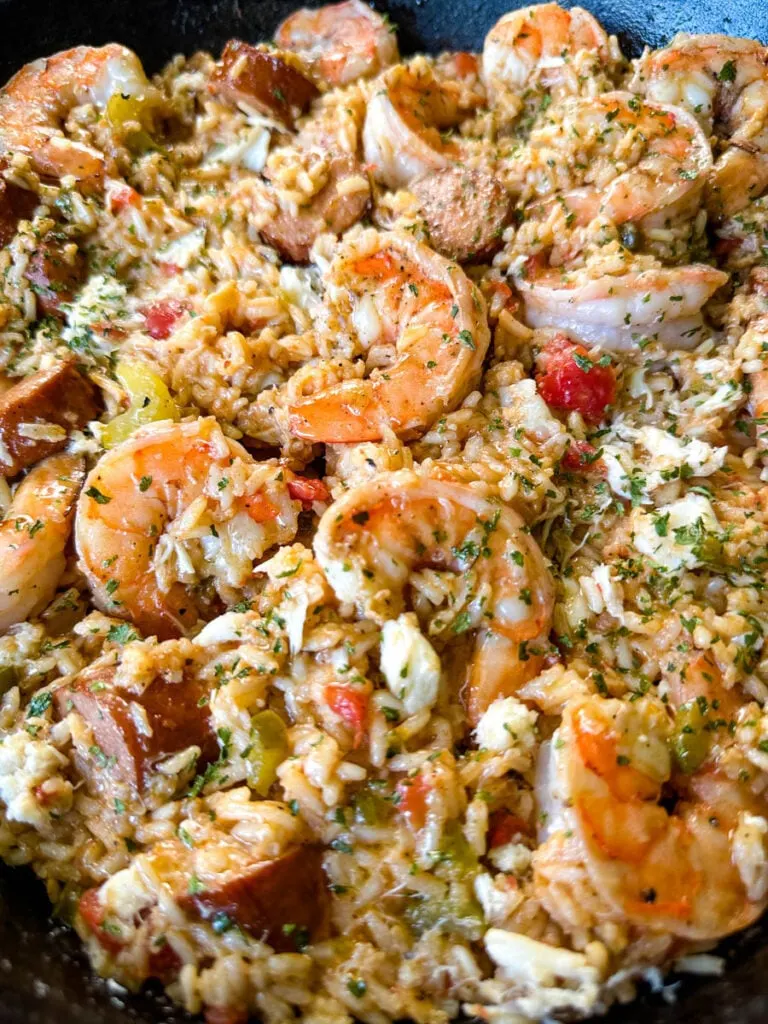 Creole shrimp jambalaya with crab in a cast iron skillet