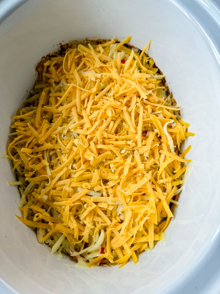 hash brown casserole with cheese in a Crockpot slow cooker