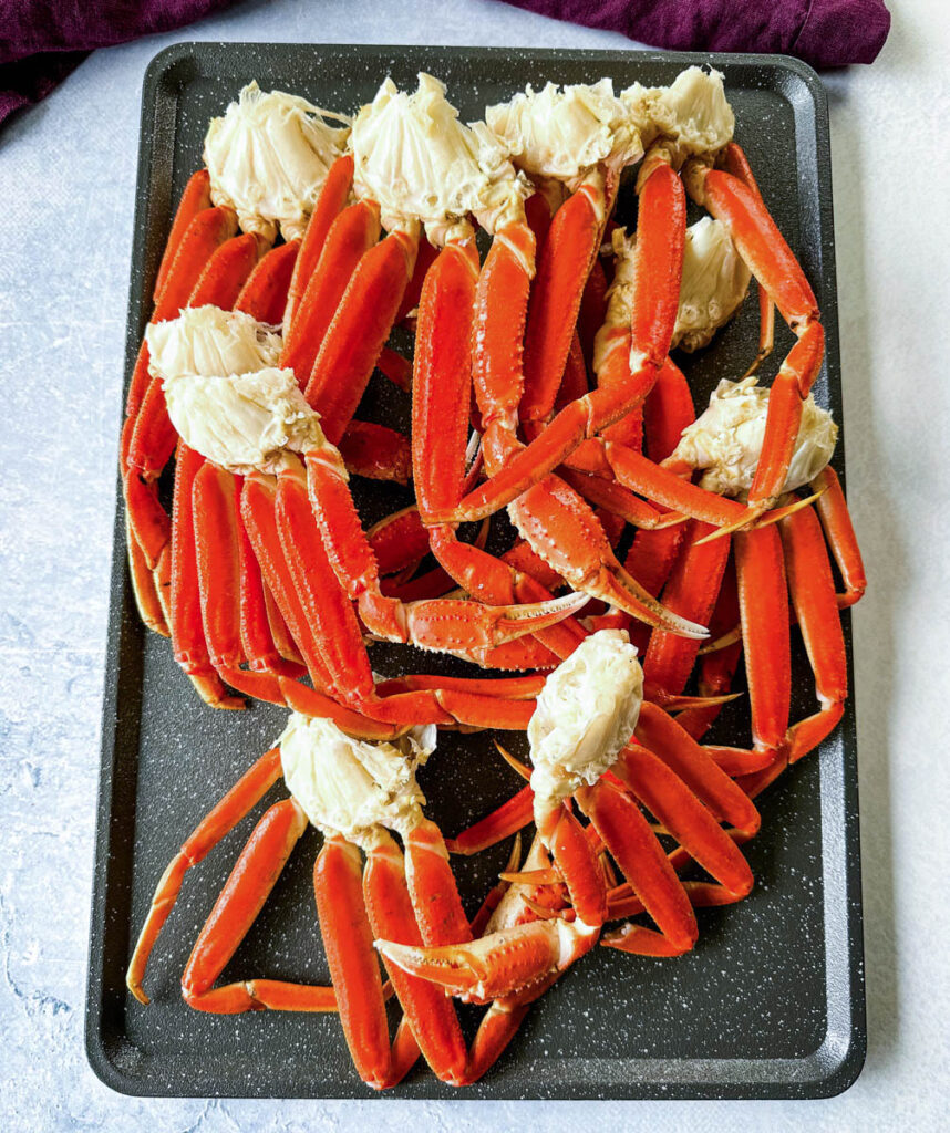 smoked crab legs on a sheet pan