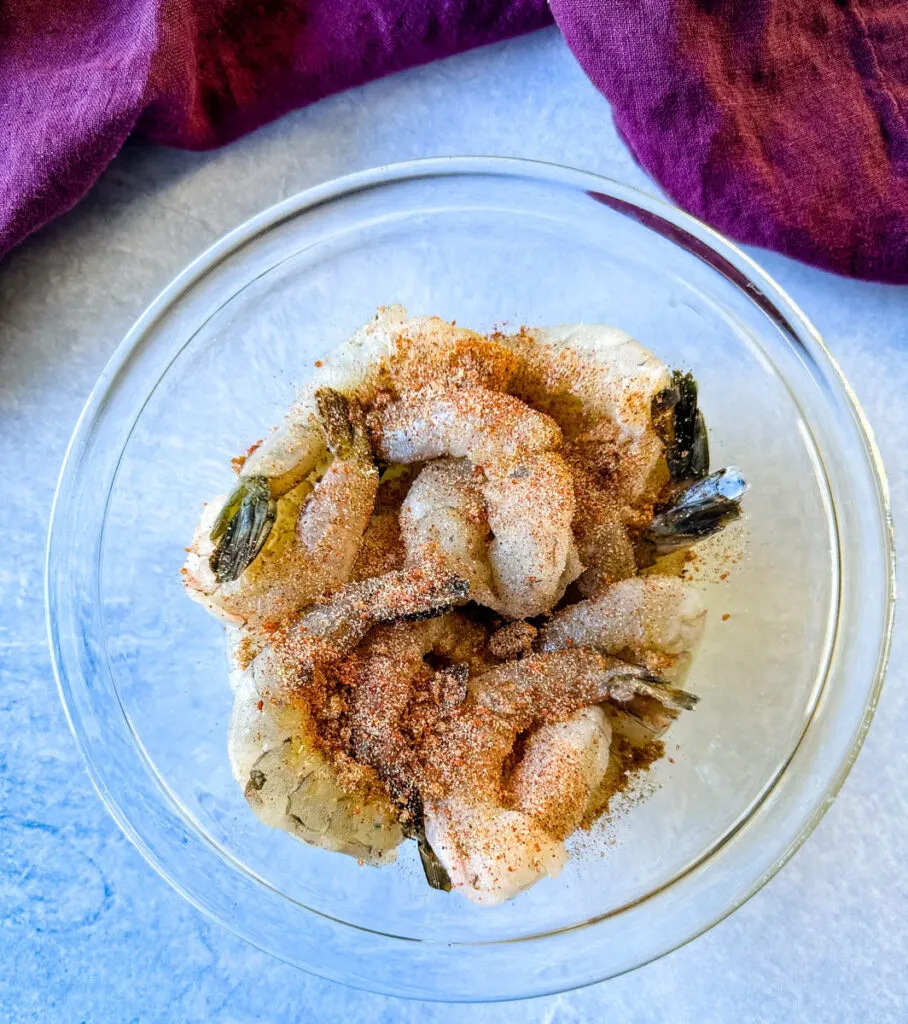 seasoned raw shrimp in a glass bowl