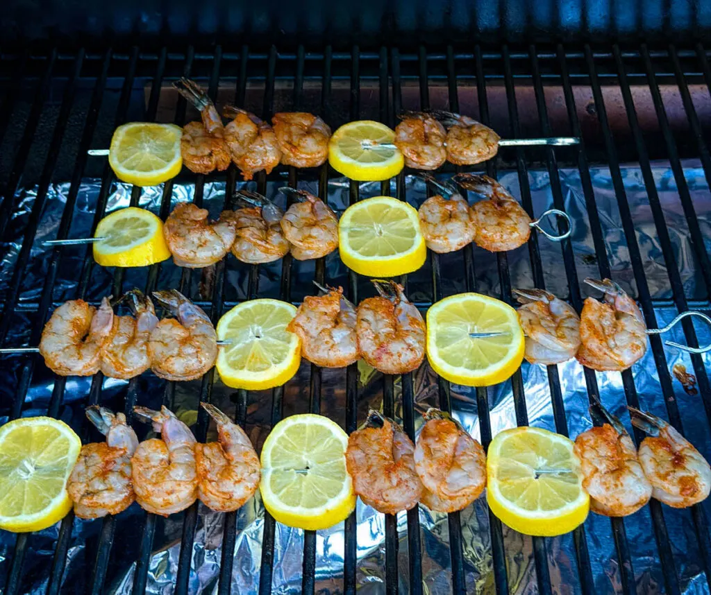 smoked shrimp on skewers with lemon on a Traeger smoker grill