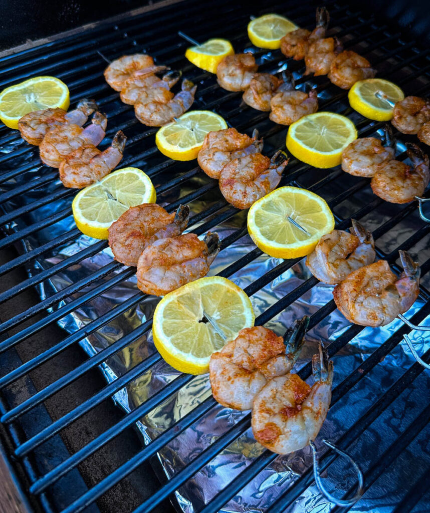 smoked shrimp on skewers with lemon on a Traeger smoker grill