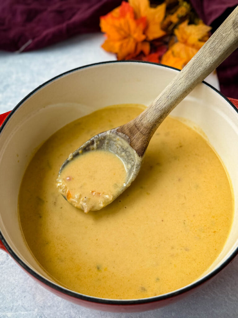 beer cheese soup with bacon in a red Dutch oven