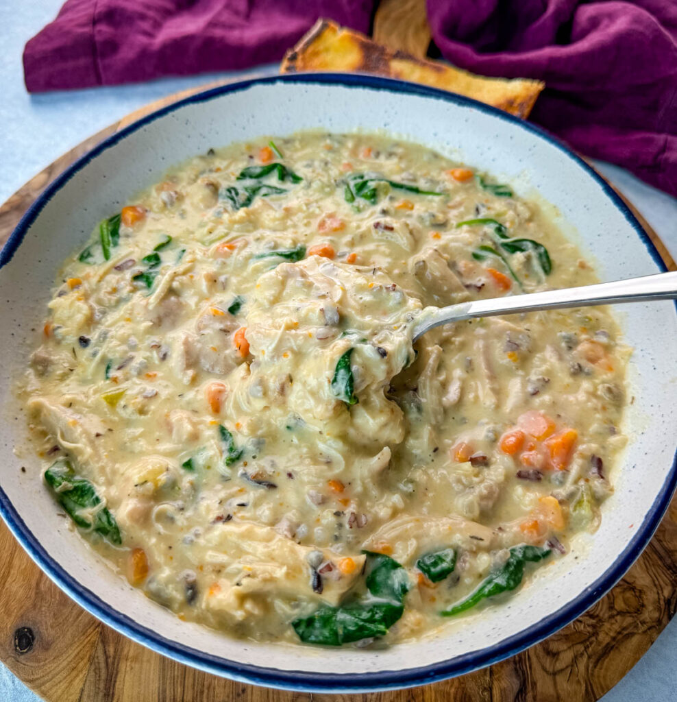 chicken wild rice soup in a white bowl with a spoon