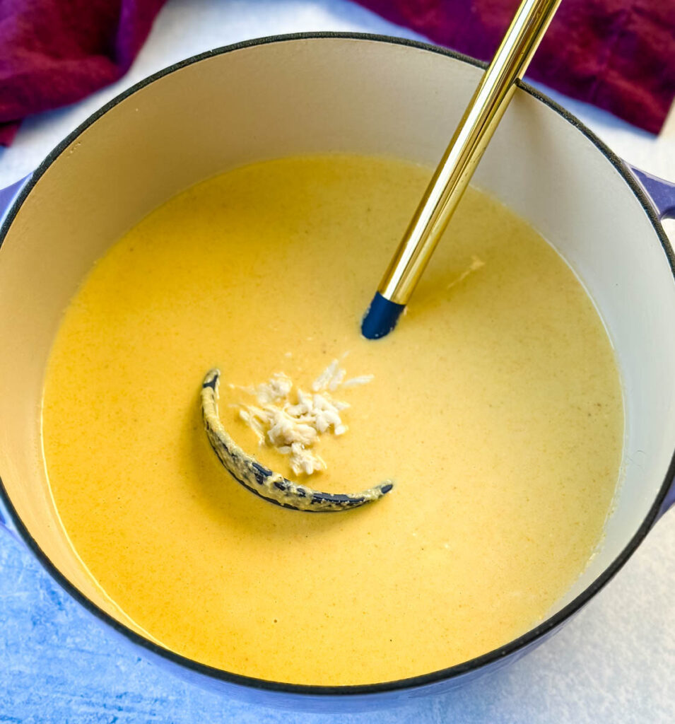 crab bisque in a Dutch oven with a spoon and lump crab meat