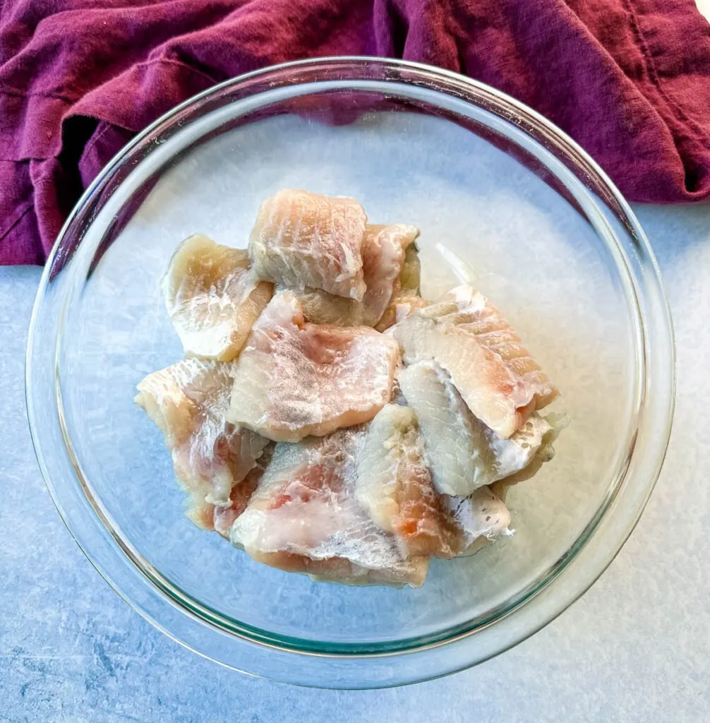 raw catfish nuggets in a glass bowl