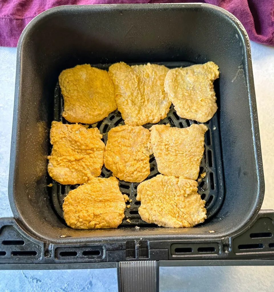 uncooked catfish nuggets in an air fryer