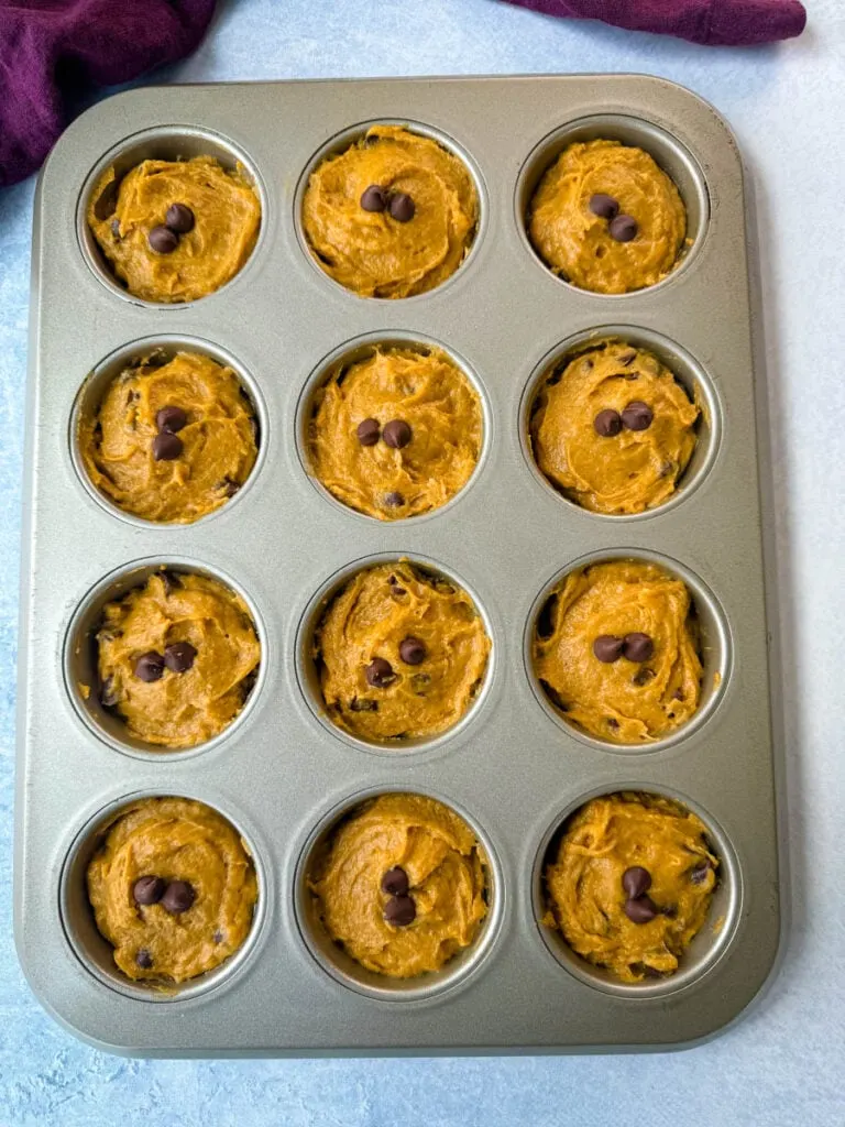 unbaked pumpkin protein muffins in a muffin tin