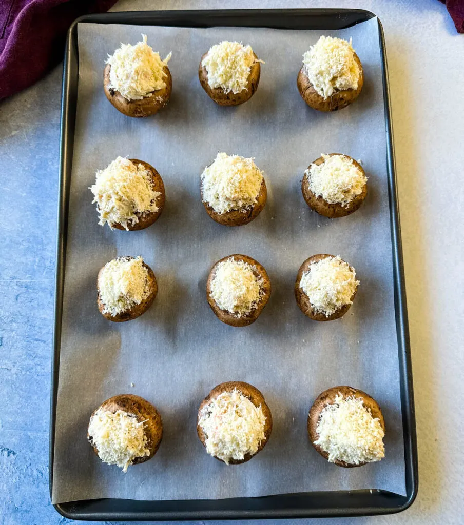 unbaked seafood stuffed mushrooms with crab and shrimp on a sheet pan