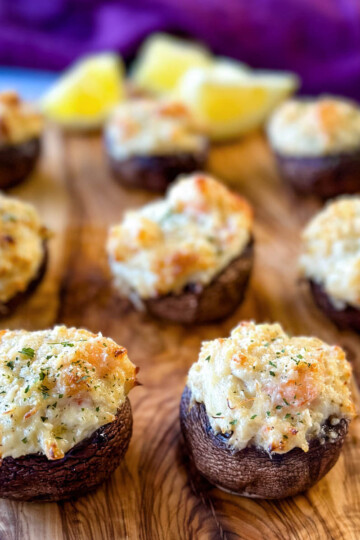 seafood stuffed musharooms with crab and shrimp on a flat surface