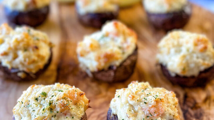 seafood stuffed musharooms with crab and shrimp on a flat surface